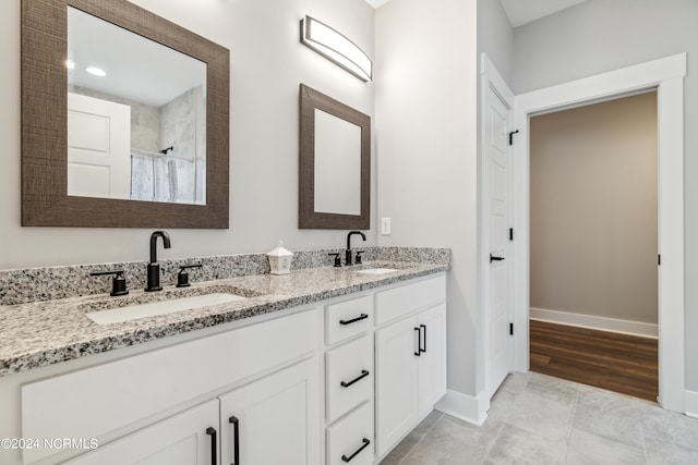 bathroom featuring vanity, hardwood / wood-style flooring, and curtained shower