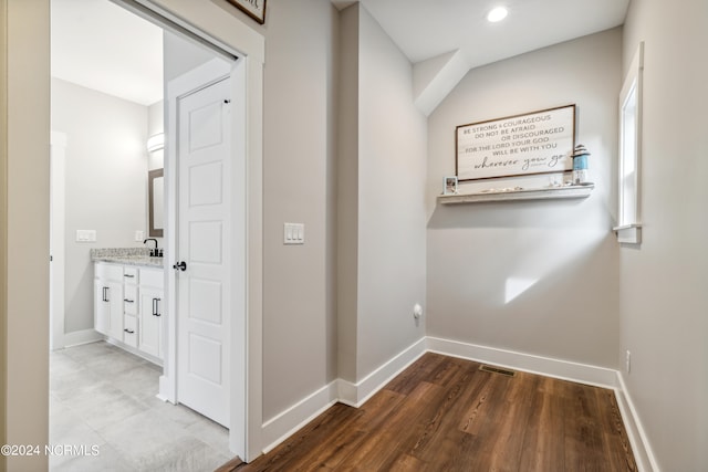 hall featuring hardwood / wood-style flooring and sink