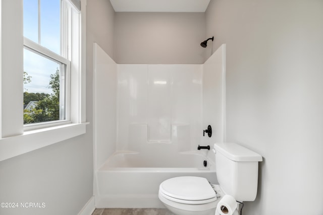 bathroom featuring shower / washtub combination and toilet