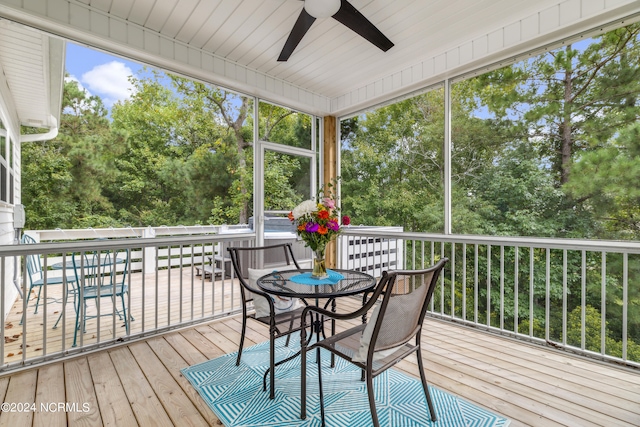 wooden deck featuring ceiling fan