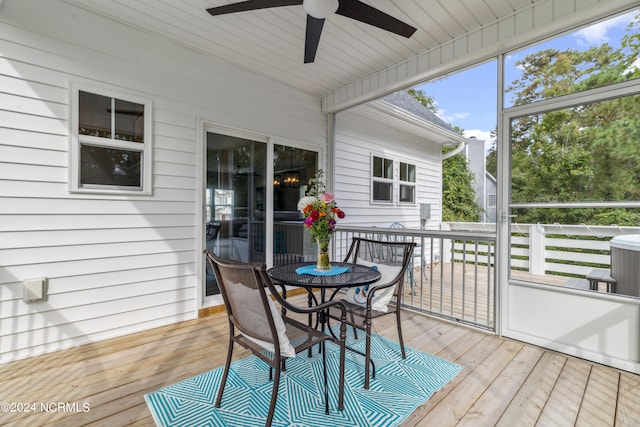 sunroom featuring ceiling fan and plenty of natural light