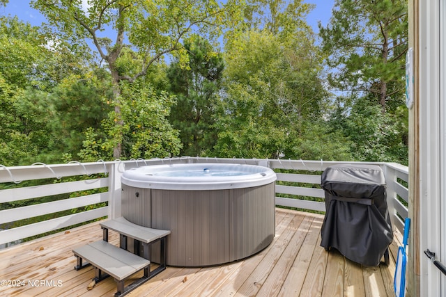 wooden deck with a hot tub