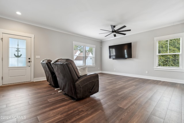 living room featuring ornamental molding, ceiling fan, and dark hardwood / wood-style floors