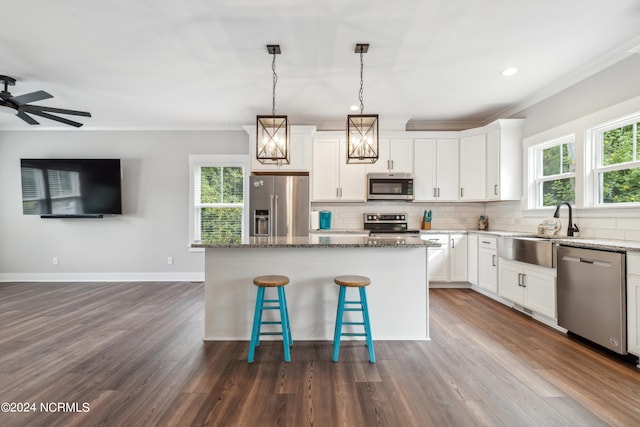 kitchen featuring a healthy amount of sunlight, a kitchen island, and stainless steel appliances