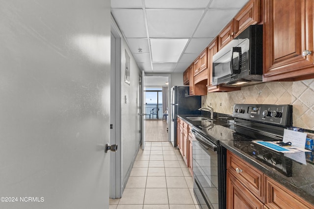 1501 S Ocean Blvd Unit 1235, Myrtle Beach, SC 29577 - kitchen with decorative backsplash, a drop ceiling, brown cabinets, black appliances, and a sink