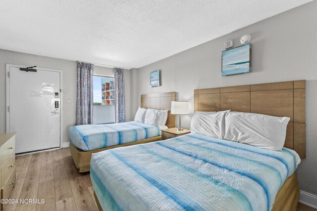 1501 S Ocean Blvd Unit 1235, Myrtle Beach, SC 29577 - bedroom featuring a textured ceiling and light wood-style flooring