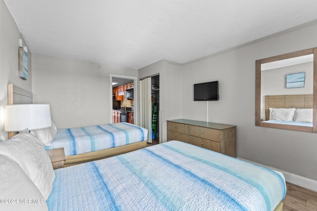 1501 S Ocean Blvd Unit 1235, Myrtle Beach, SC 29577 - bedroom with light wood-type flooring, baseboards, and a closet