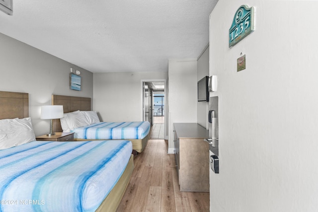 1501 S Ocean Blvd Unit 1235, Myrtle Beach, SC 29577 - bedroom featuring light wood-style floors and a textured ceiling