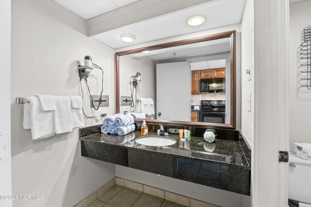 1501 S Ocean Blvd Unit 1235, Myrtle Beach, SC 29577 - bathroom featuring tile patterned flooring, tasteful backsplash, and vanity