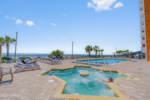 1501 S Ocean Blvd Unit 1235, Myrtle Beach, SC 29577 - community pool with a patio, a water view, and fence