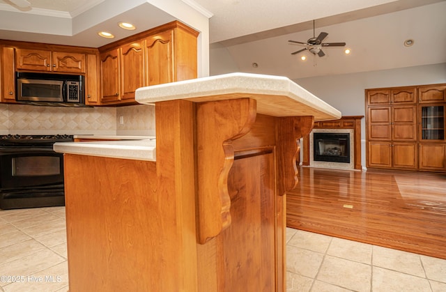 kitchen featuring tasteful backsplash, ceiling fan, light tile patterned floors, black electric range, and crown molding