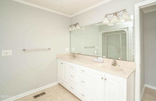 bathroom featuring tile patterned floors, vanity, ornamental molding, and a shower with door