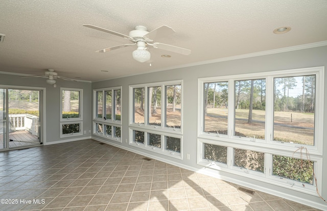 unfurnished sunroom featuring ceiling fan