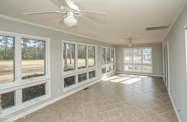 unfurnished sunroom featuring ceiling fan