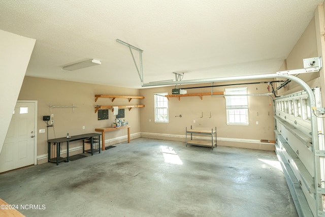 garage featuring a garage door opener and a workshop area