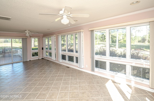 unfurnished sunroom with ceiling fan