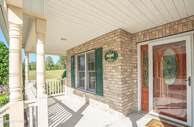 view of exterior entry featuring a porch