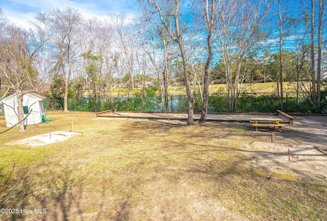 view of yard with a water view and a storage shed