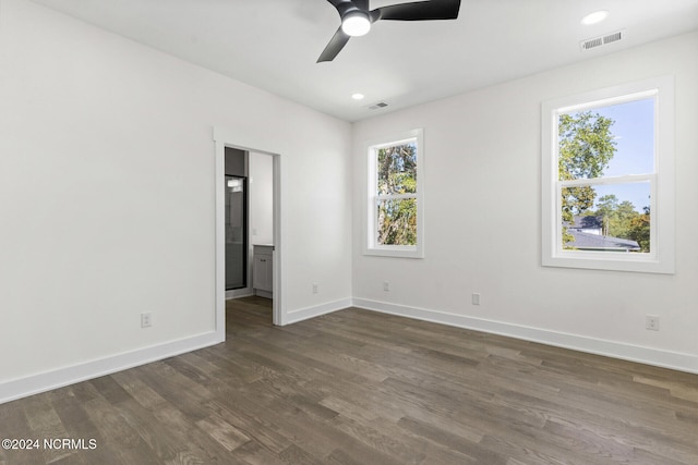 spare room with dark hardwood / wood-style floors and ceiling fan