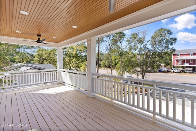 wooden deck with a porch and ceiling fan