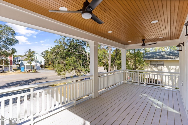 wooden deck featuring a porch and ceiling fan