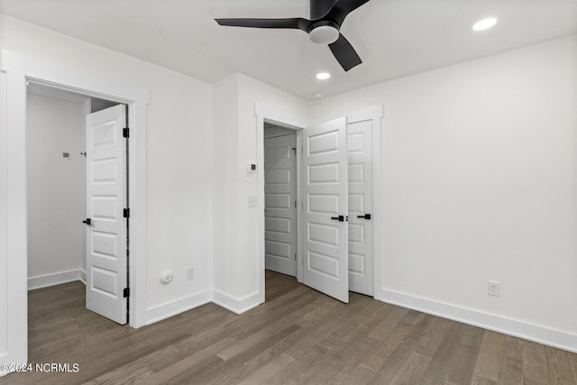 unfurnished bedroom featuring ceiling fan, wood finished floors, baseboards, a closet, and recessed lighting