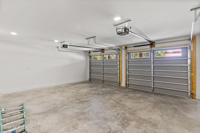 garage with baseboards, a garage door opener, and recessed lighting