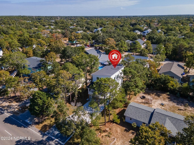 bird's eye view with a wooded view and a residential view