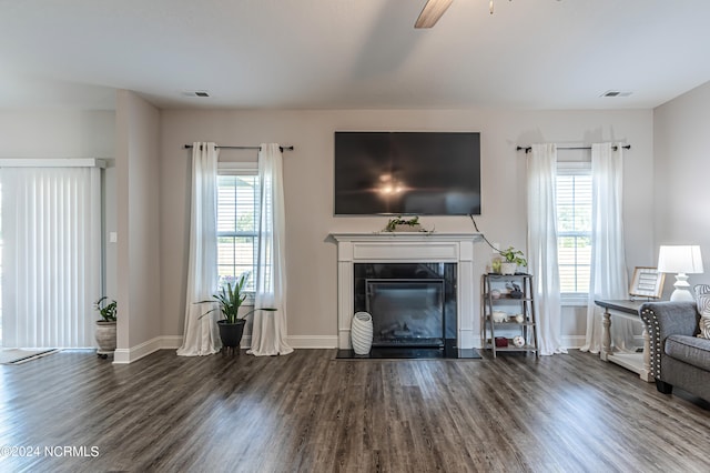 unfurnished living room featuring ceiling fan and dark hardwood / wood-style flooring