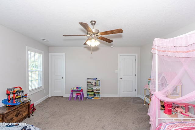 interior space with carpet flooring, ceiling fan, and a textured ceiling