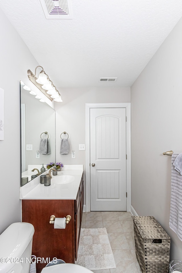 bathroom with tile patterned floors, vanity, and toilet