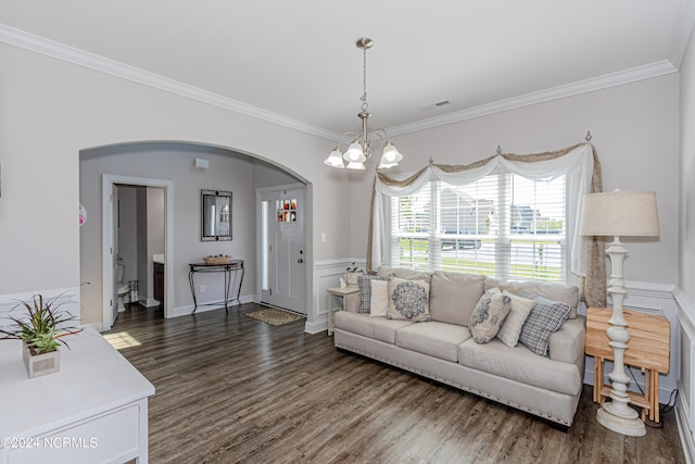 living room with crown molding, dark hardwood / wood-style flooring, and a notable chandelier