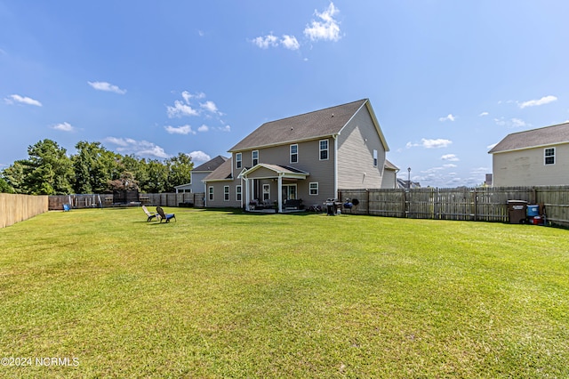 back of property featuring a yard