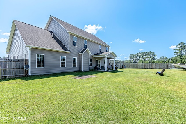 rear view of house with a lawn