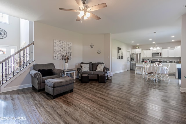 living room with dark hardwood / wood-style floors and ceiling fan