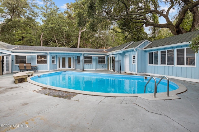 view of pool featuring a patio and french doors