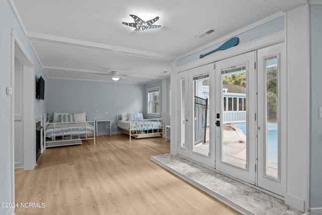 bedroom with french doors, light hardwood / wood-style floors, and access to exterior