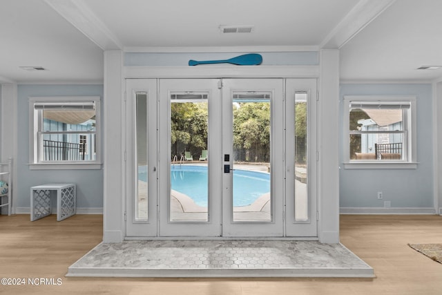 entryway featuring french doors, light hardwood / wood-style flooring, and a wealth of natural light