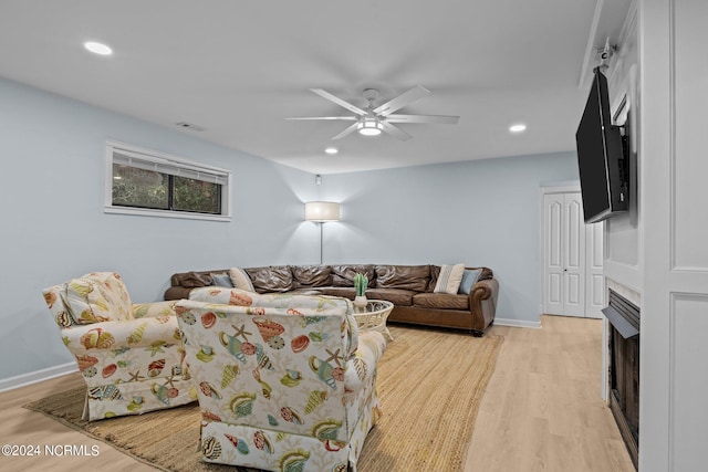 living room featuring ceiling fan and light wood-type flooring