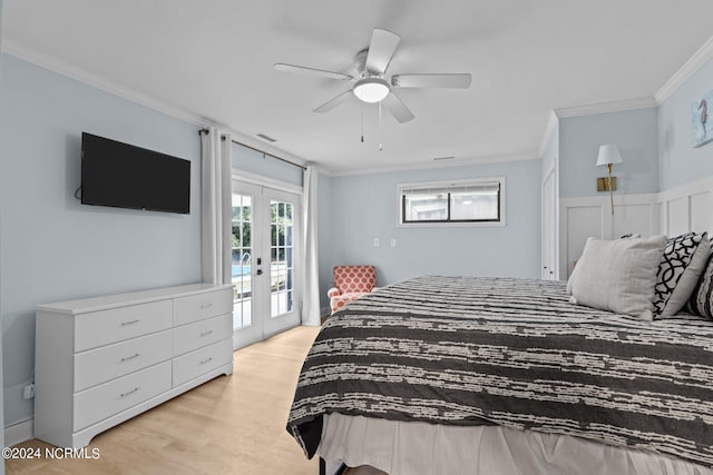 bedroom featuring light hardwood / wood-style flooring, ornamental molding, multiple windows, and access to outside