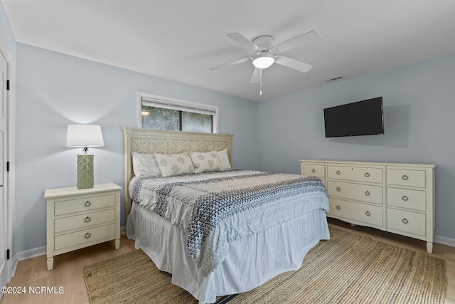 bedroom with ceiling fan and light hardwood / wood-style flooring