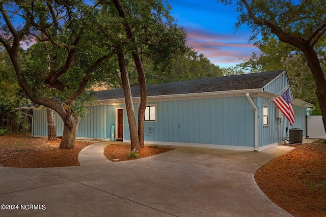 ranch-style home featuring cooling unit