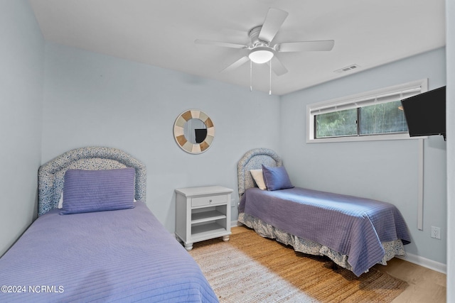 bedroom featuring light wood-type flooring and ceiling fan