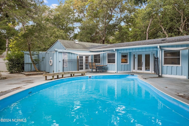 view of pool featuring a storage shed, a patio, and french doors