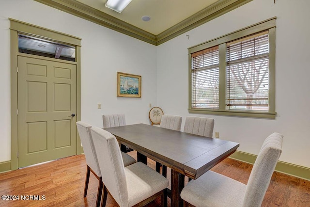 dining area featuring ornamental molding and light hardwood / wood-style floors