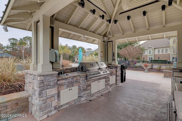 view of patio / terrace featuring a gazebo, an outdoor kitchen, sink, and area for grilling