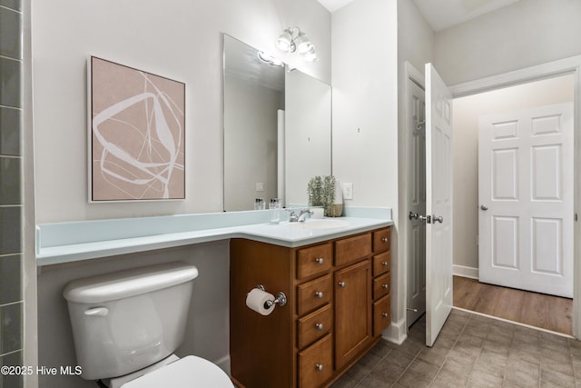 bathroom featuring vanity and toilet