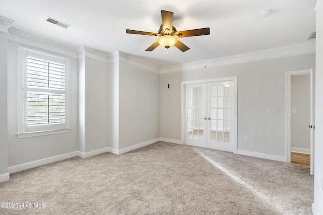 carpeted spare room featuring ornamental molding, french doors, and ceiling fan