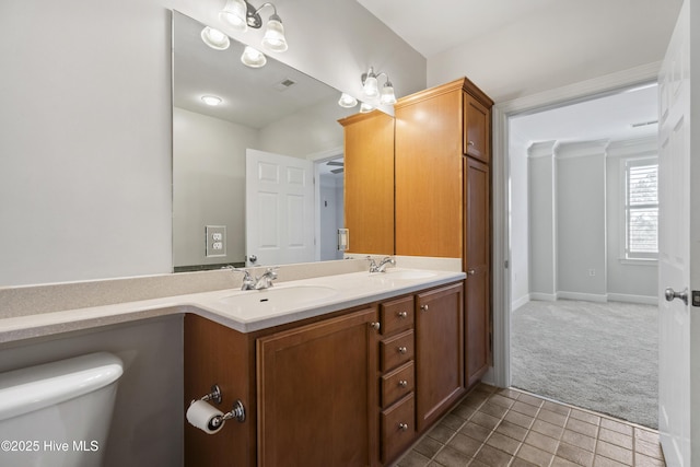 bathroom featuring tile patterned flooring, vanity, and toilet