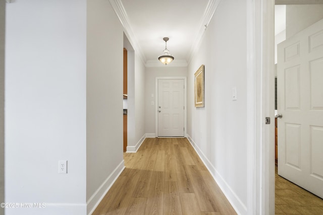 hall with crown molding and light wood-type flooring